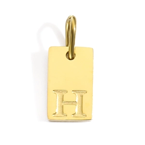 Detail view of rectangular gold-plated stainless steel pendant with letter H engraving