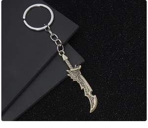 Detailed view of an antique bronze dragon-patterned metal sword keychain with ring