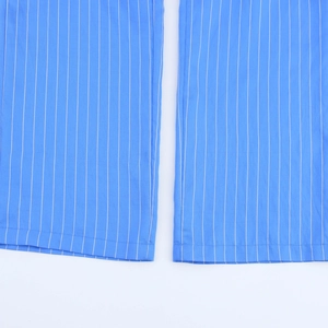 Close-up of blue vertical striped fabric texture and detailed stitching on fashion set