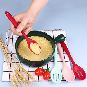 Silicone slotted and solid kitchen spoons set shown scooping food from a green cooking pot