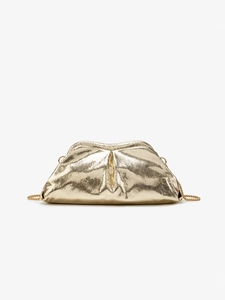 Macro detail of golden snake-textured cloud clutch featuring a metallic chain strap
