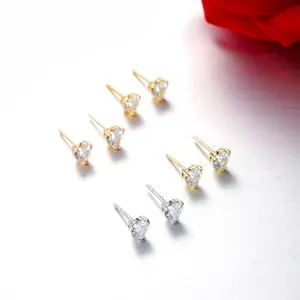Detailed view of heart-shaped zircon stud earrings in gold and silver finish