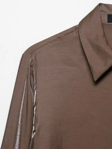 Detail of coffee brown long sleeve shirt showing silky fabric and glossy shoulder tape