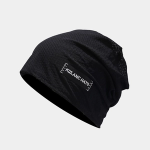 Detail of black knitted beanie with KIZLANC HATS woven label and elastic texture