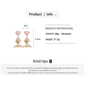 Macro detail of alloy fish earrings with pink hearts and rhinestones on 5.5cm drop