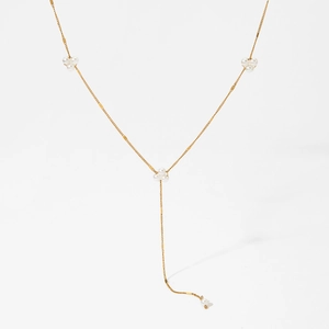 Elegant gold Y-shaped necklace with white pearl clusters on a clean white background
