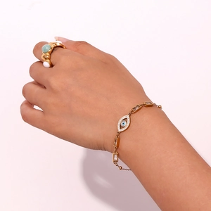 Detail shot of 18K gold plated evil eye bracelet with white zircon and matching ring