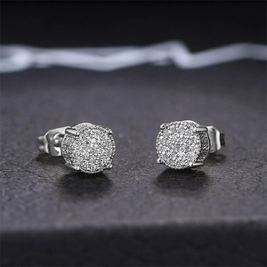 Close-up of hip hop silver stud earrings with micro-paved sparkling cubic zirconia
