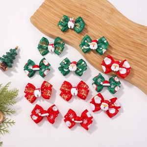 Christmas bow hair clips set with Santa and polar bear resin charms on a tray