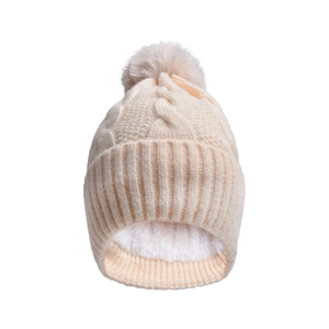 Detailed view of winter cable knit beanie featuring faux fur pom and thick fleece lining