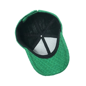 Internal detail of bright green knitted baseball cap showing inner lining and stitching
