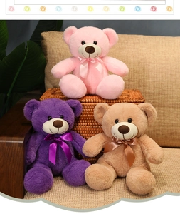 Three colorful plush teddy bears in pink, purple and tan with decorative ribbon bows