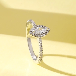 Macro detail of silver ring featuring large water drop zircon and pave setting accents