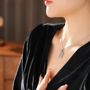Detailed close-up of a silver hollow square pendant necklace with intricate zircon details