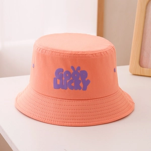 Detail of orange cotton bucket hat for kids with purple GOOD LUCKY embroidery and wide brim