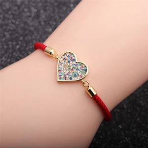 Red braided rope heart bracelet with colorful zircon stones on female model's wrist