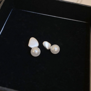 Minimalist geometric silver earrings with irregular faux pearls in a black jewelry box