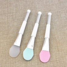 Three eyelash extension cleaning brushes in grey, light blue and pink with silver ferrule