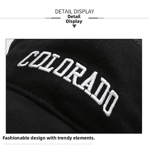 Detailed close-up of white 3D Colorado embroidery on a premium black cotton baseball cap