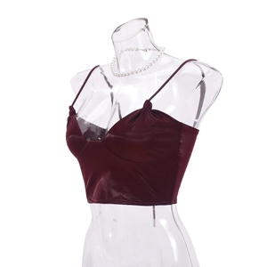 Detailed close-up of dark red PU leather camisole with thin straps and glossy texture