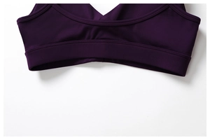 Detailed view of the double-needle stitching on a dark purple recycled yoga sports bra
