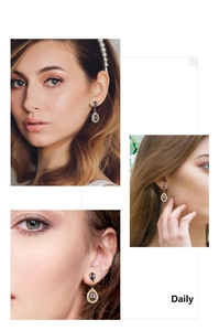 Detailed view of drop earrings featuring purple pear-cut stones and crystal halo