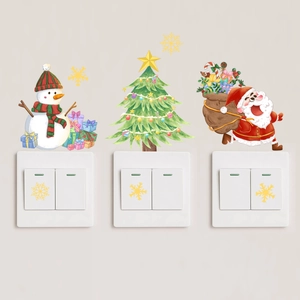 Glow-in-the-dark Christmas switch stickers featuring Santa and Snowman on wall