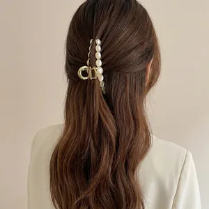Elegant gold alloy shark clip with opal-like stones for thick hair shown on a model