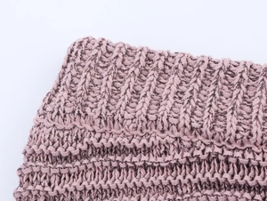 Close-up detail of lavender knitted fabric showing thick crochet texture and yarn patterns