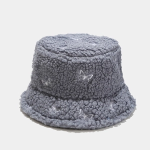 Detail of grey teddy fleece bucket hat featuring delicate white butterfly embroidery
