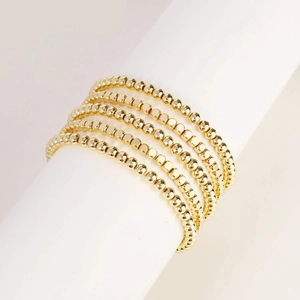 Set of five gold beaded stretch bracelets with smooth and faceted metallic spheres