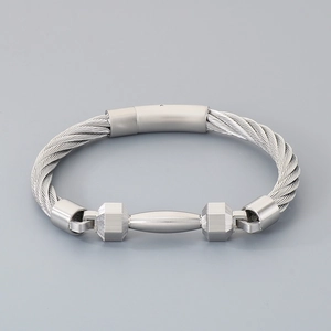 Detailed close-up of a silver stainless steel cable bracelet with a matte barbell charm
