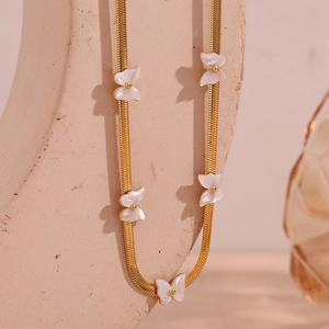 Detail of 18K gold-plated snake chain featuring five elegant white shell butterfly charms