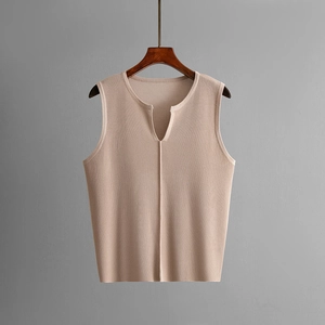 Detail of beige ribbed knit sleeveless vest featuring a V-neckline and textured fabric