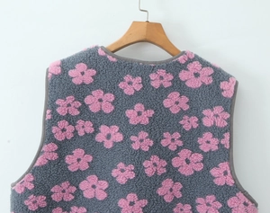 Close-up of soft grey fleece vest with pink floral pattern and textile edging detail