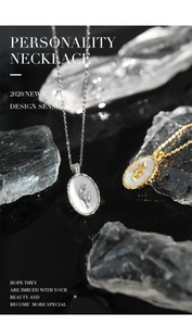 Macro shot of tulip shell pendant necklaces in gold and silver over ice cubes
