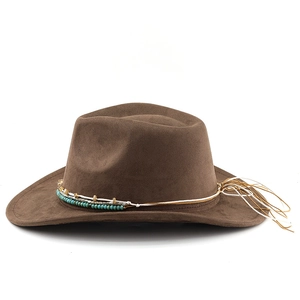 Close-up of beaded ethnic band with turquoise accents and fringe on a brown suede hat