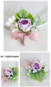Detail of light purple silk rose boutonniere with green leaves and pink ribbon trim