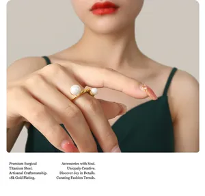 Close-up of 18K gold plated titanium steel twist ring with pearls on a finger