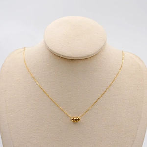 Minimalist gold titanium steel necklace featuring five small smooth circular ring pendants
