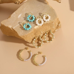 Detailed view of luxury 14K gold plated earrings with freshwater pearls and turquoise stones