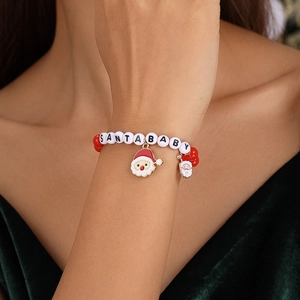 Detail of Christmas beaded bracelet with Santa charms and Santa Baby letter beads