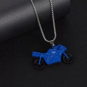 Detailed close-up of a blue and silver motorcycle pendant on a punk style long chain