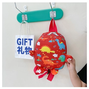 Detail of red cartoon dinosaur backpack showing durable canvas fabric and dual zippers