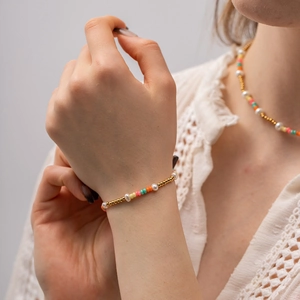 18k gold stainless steel beaded bracelet with pearls and colorful glass beads on a model