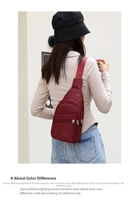 Burgundy red crossbody chest bag with earphone port and multiple zipper pockets