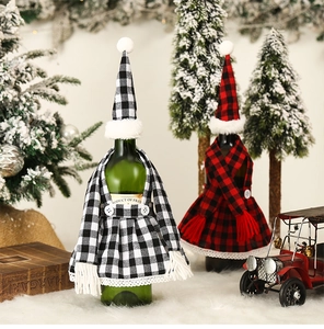 Macro detail of Christmas wine bottle cover set with plaid pattern and festive lace