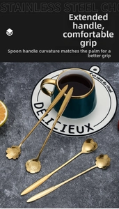 Set of 4 gold stainless steel long-handle spoons with floral heads on a coffee cup