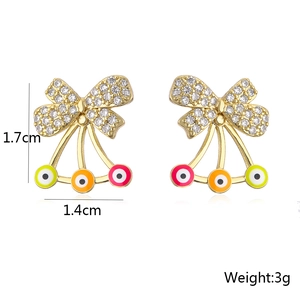 Detailed view of gold bow earrings with cherry evil eye charms and 1.7cm size scale