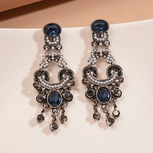 Detail of vintage silver earrings with dark blue crystal, pearls and hanging tassels